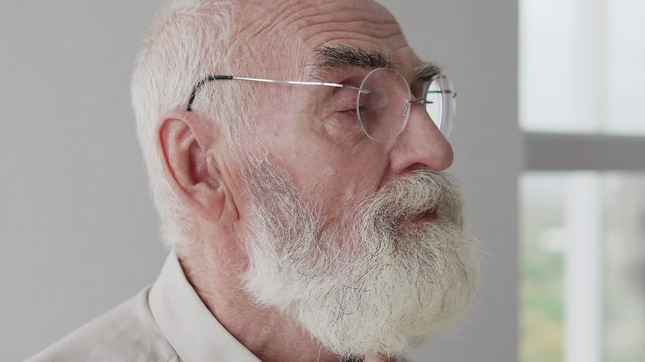 Aged man with gray hair and beard folding hands praying God, sincere believing