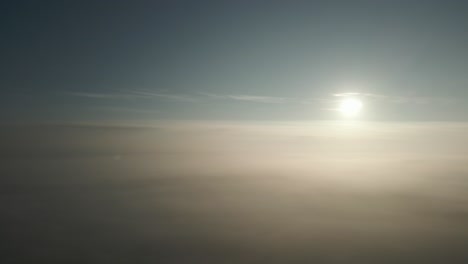 sun above the clouds aerial panning shot