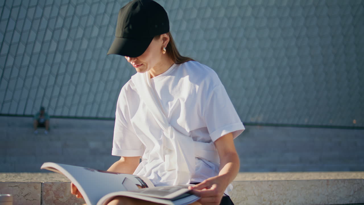 Trendy woman reading magazine sitting urban stairs summer closeup. Relaxed lady