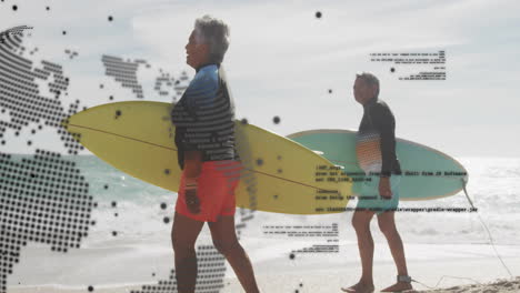senior couple walking along beach carrying surfboards, showing tech map overlay and code lines