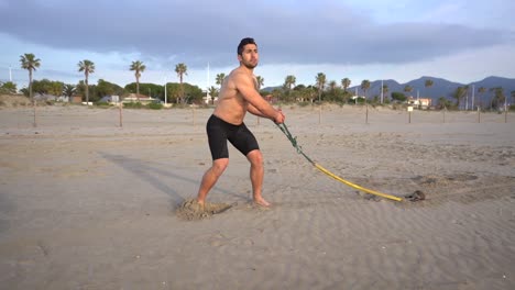metabolic workout on the beach with rubber dorsal variant and kettlebell