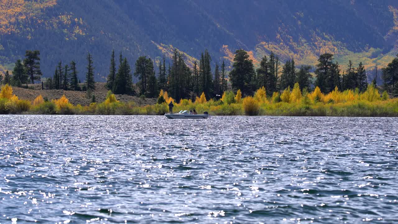 Men fishing in a lake against a background of fall colors in the Rocky Mountains of Colorado