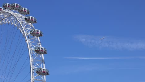 ferris wheel with airplane in the background