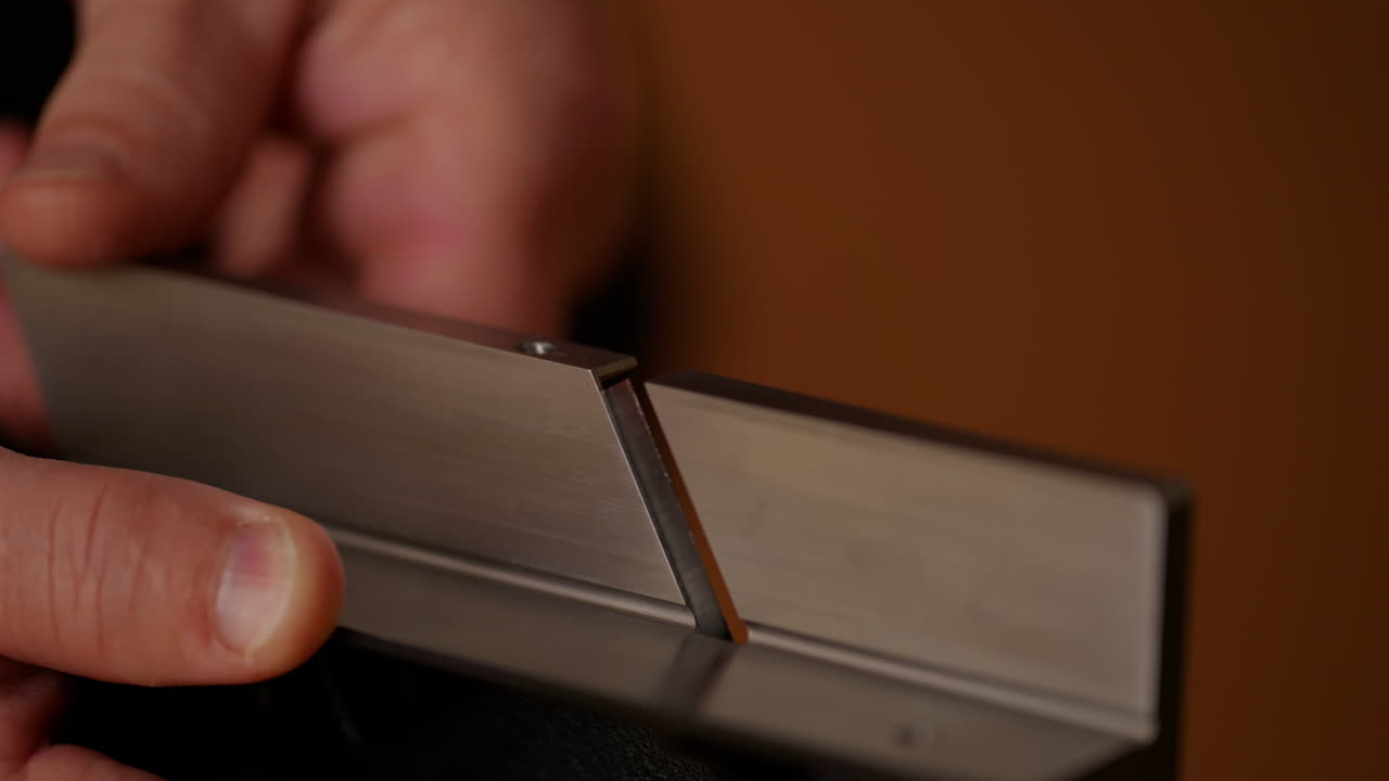 Craftsman focuses on a precision tool, aligning it carefully with a metal surface in a workshop. The attention to detail highlights skilled craftsmanship