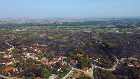 aerial revealing the disaster of a wildfire around a small village in northern greece, august 2023
