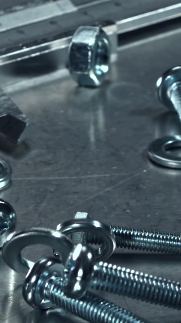 Metal Nuts, Bolts, and Washers Falling in Slow Motion