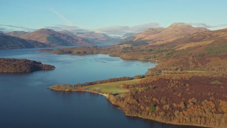 high views across the lake of loch lomond and the trossachs national park on a warmly lit sunny autumn day in scotland