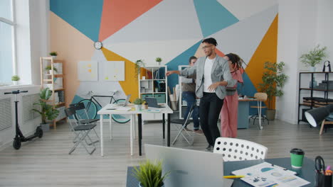 happy team dancing in a modern office