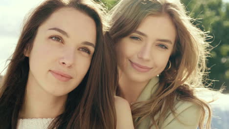 two women posing outdoors