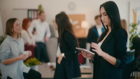 Businesswoman-using-digital-tablet-in-office.