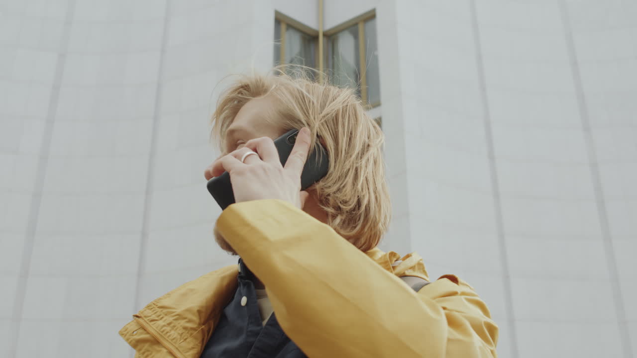 Young Man Talking on Mobile Phone on Street