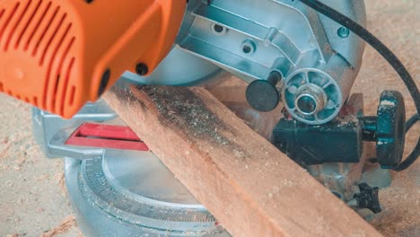 carpenter using circular saw for cutting wooden boards