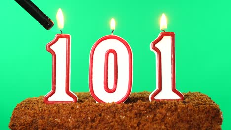 cake with the number 101 lighted candle. chroma key. green screen. isolated