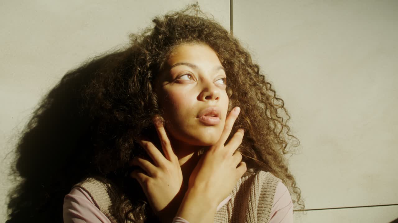 Woman with curly hair in natural light