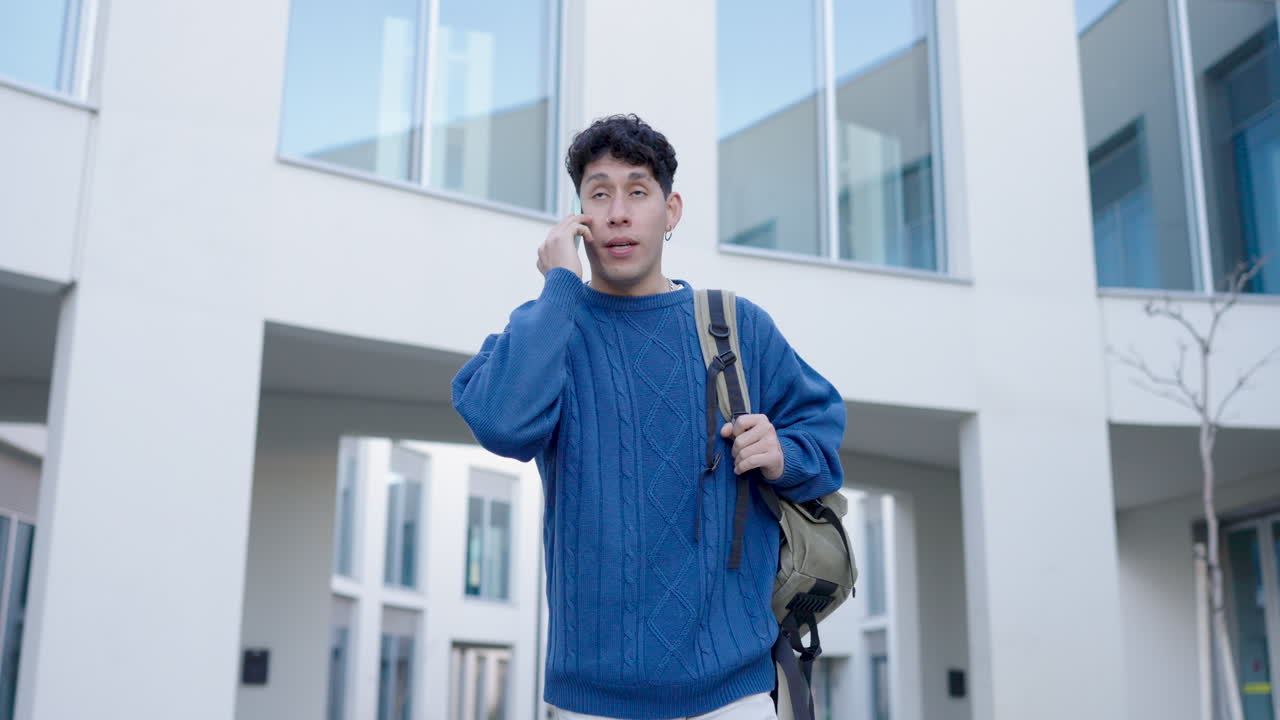 Student walking and talking on phone near university