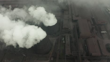 aerial view of an industrial pipe pollutes the air next to people living in the city. create a greenhouse effect