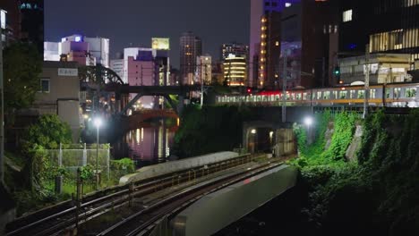 trains passing in the night in tokyo, ocha no mizu station background view