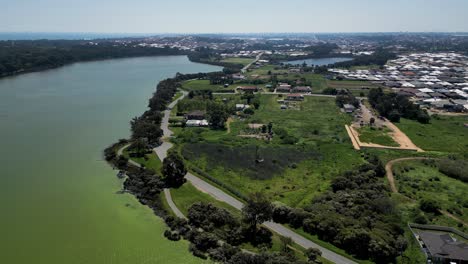 aerial view of lake coogee on sunny summer day and cockburn road along shore in suburb of perth, western australia