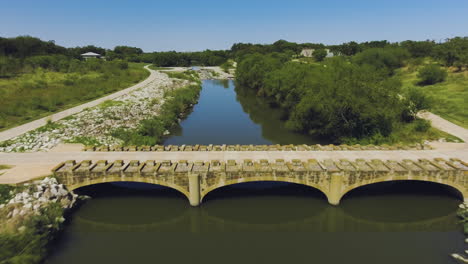 a trail small bridge going over the san antonio river at the mission reach segment