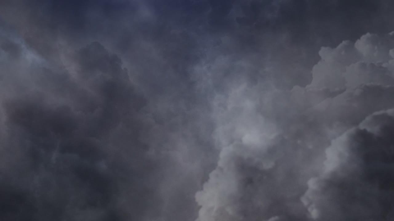 Dark clouds and thunderstorm in gray clouds in dark sky