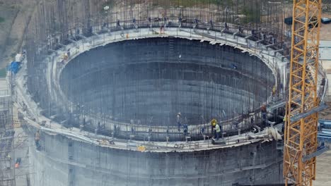 cement factory under construction with high concrete plant structure at industrial production area