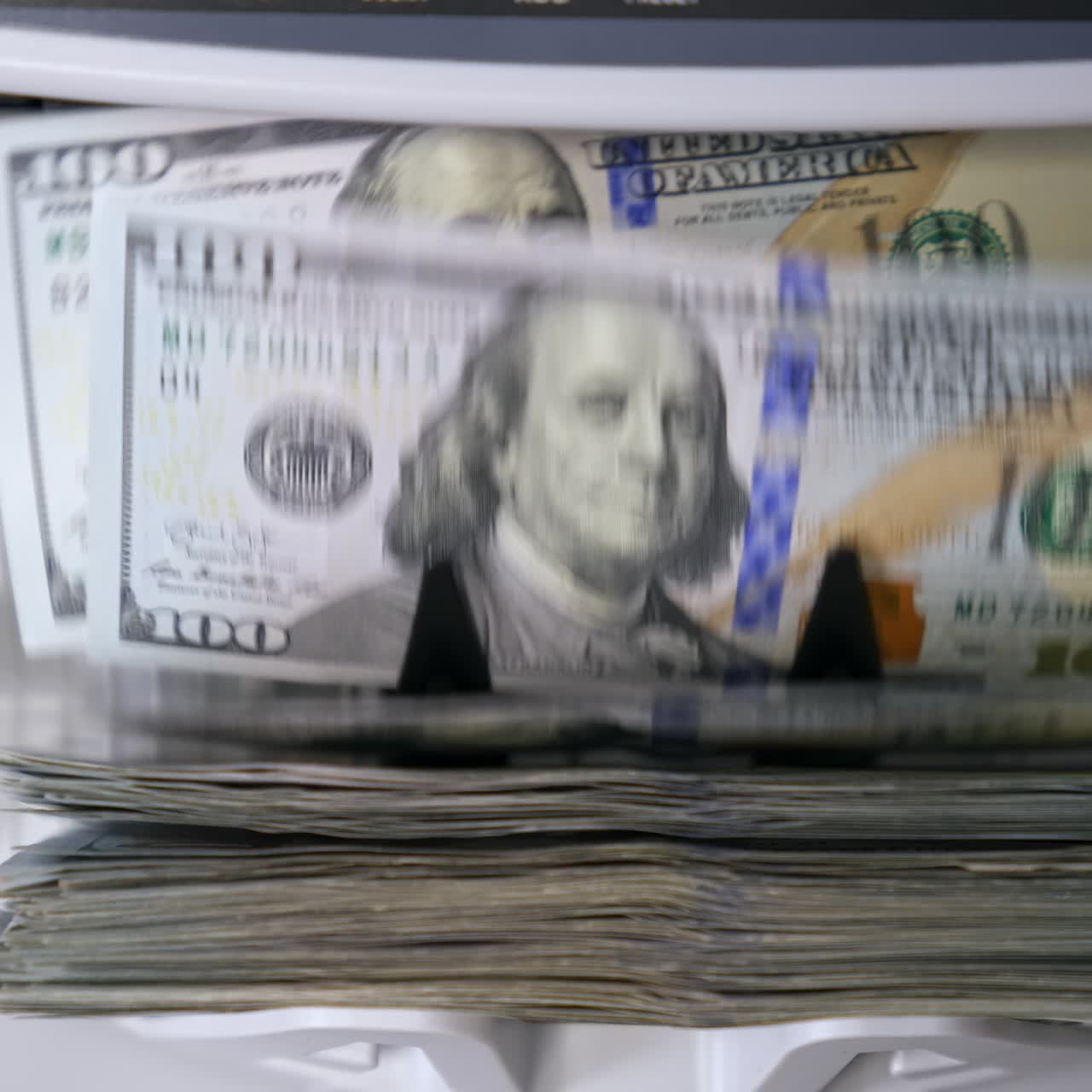 Money counting equipment for paper money calculation. Automatic mechanism for bank financial operations. Currency exchange of one hundred usd. Closeup currency counting machine counting dollar bills