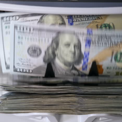 money counting equipment for paper money calculation. automatic mechanism for bank financial operations. currency exchange of one hundred usd. closeup currency counting machine counting dollar bills