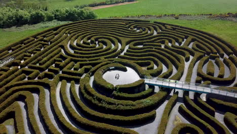 Aerial-view-passing-over-garden-maze,-peace-maze