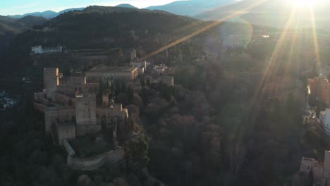 Alhambra-Palace-Drone,-Fortress-Complex-With-Sunrays-In-Granada,-Andalusia,-Spain