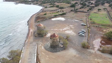 drone gracefully glides around old war towers, offering breathtaking panoramic views of the city and  mountains.