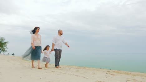 Happy-Family-Of-Three-People-Running-On-The-Beach-05