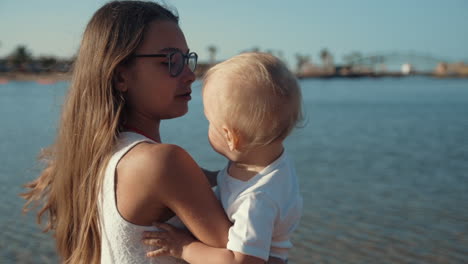 Adorable-children-enjoying-sunny-morning-at-beautiful-seashore-at-sunrise.