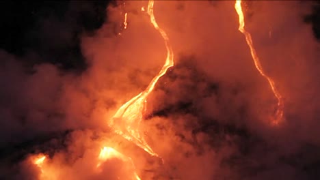 spectacular nighttime lava flow from a volcano into ocean 4