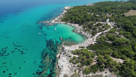 halkidiki beach kavourotrypes and clear blue sea coastline in greece - aerial 4k