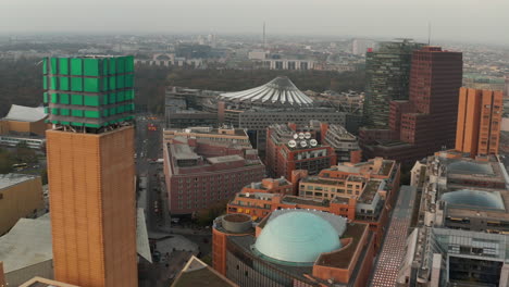 Slide-and-pan-footage-of-Potsdamer-Platz-neighbourhood.-Fly-around-top-of-tall-business-building.-Berlin,-Germany