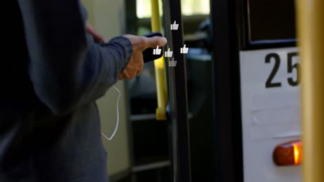 multiple thumbs up icons floating against caucasian boy using smartphone in the bus