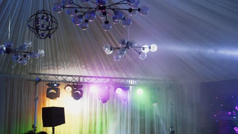 flashing colorful lights over the stage. bright lasers shining brightly and shimmering in the modern night club.
