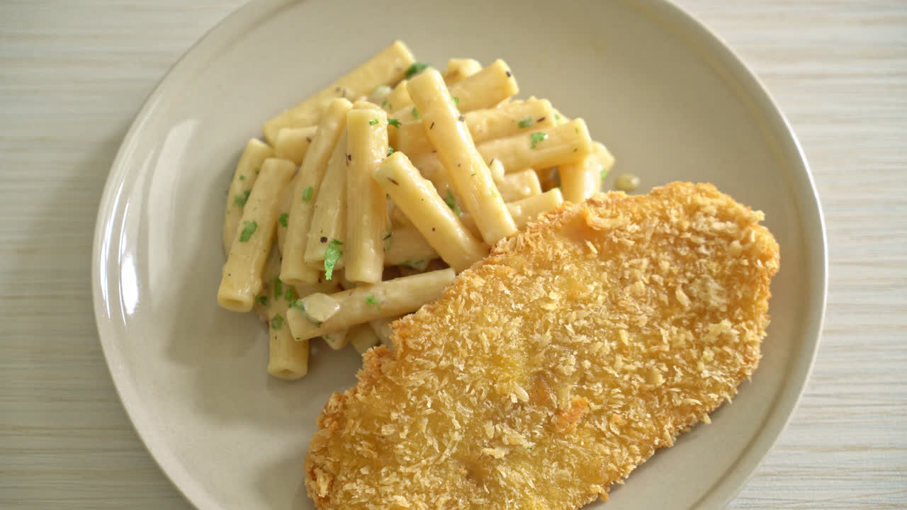Pasta penne quadrotto casera con salsa de crema blanca y pescado frito