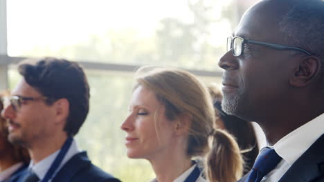 delegates at business conference listening to speech