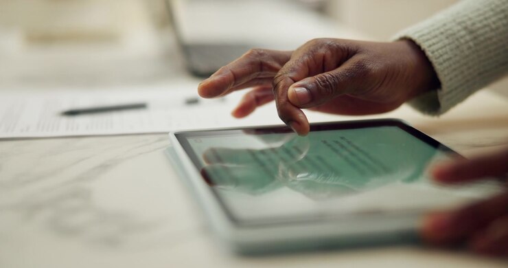 Person Using Digital Tablet for Work in Office