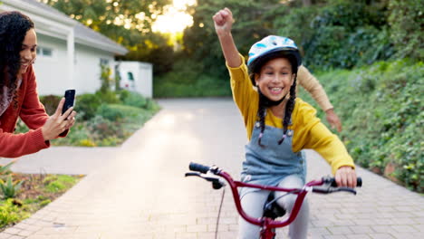 mother, father and kid on bike learning