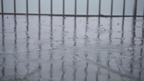 Slow-Motion-Shot-Of-Rain-Drops-Falling-Over-Stone-Tiles
