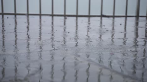 slow motion shot of rain drops falling over stone tiles