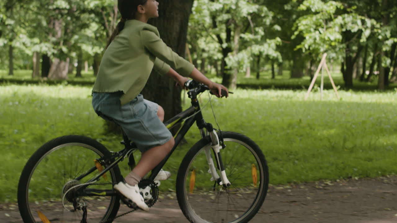 Girl riding bicycle in park