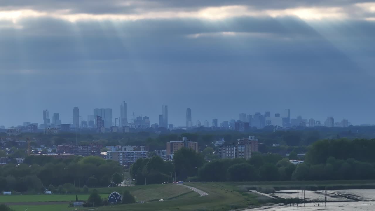 Sunlight Filtering Through the Clouds on Rotterdam's Skyline Aerial View