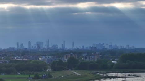 sunlight filtering through the clouds on rotterdam's skyline aerial view