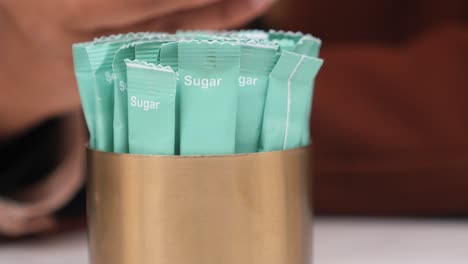 sugar packets in a golden holder