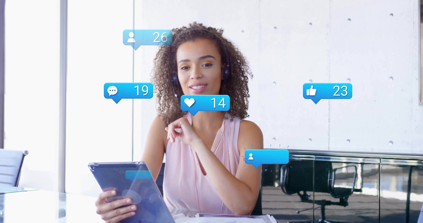 Social media manager placing blue card on tablet and tapping to monitor engagement icons floating