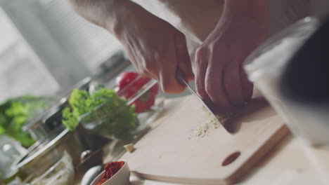 chopping garlic in a kitchen