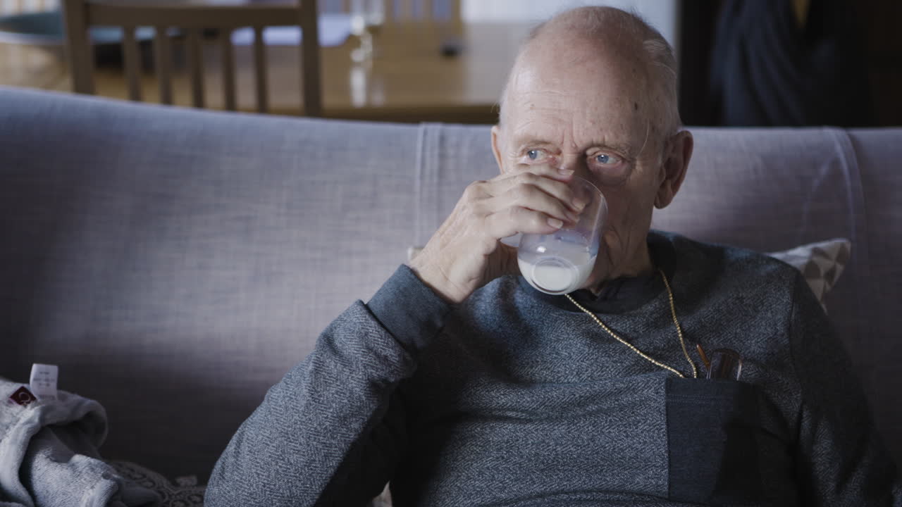 Elderly man sitting on couch